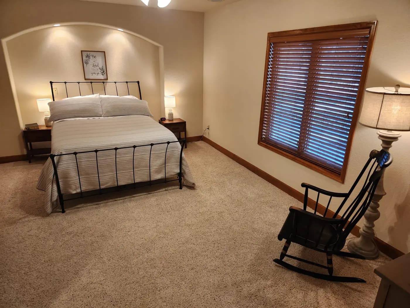 Bedroom with iron bed frame and rocking chair